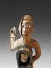 Statuette à fonction magique: statuette nkisi, de protection et de guérison. Statuette en bois, peint en ocre et blanc, reliquaire formé d'une boîte recouverte de verre ; l'oeil gauche est formé d'un clou et l'oeil droit d'un morceau de faïence. Une large fente traverse tout le visage du côté gauche. Région de Loango, République du Congo. Matériaux: bois, miroir, faïence, fer, kaolin, ocre, matières organiques. Don Théodore Thérémin - (c) musée du quai Branly, photo Patrick Gries/Valérie Torre